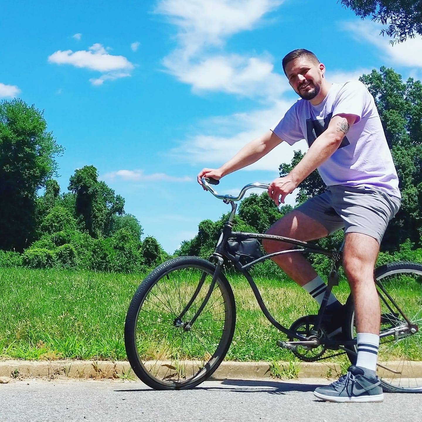 Matt Molli riding a bike in the park